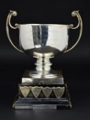 AN ELIZABETH II SILVER TWIN HANDLED TROPHY CUP, of circular form, short knopped pedestal, square