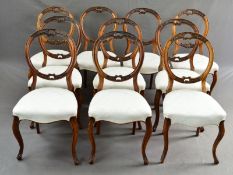 A MATCHED SET OF TEN VICTORIAN WALNUT BALLOON BACK DINING CHAIRS, with carved foliate and scroll