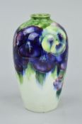 AN EARLY 20TH CENTURY WILLIAM MOORCROFT BALUSTER VASE, decorated with the Pansy pattern on cream