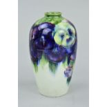 AN EARLY 20TH CENTURY WILLIAM MOORCROFT BALUSTER VASE, decorated with the Pansy pattern on cream