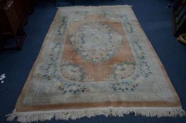 A CHINESE WOOLLEN CARPET SQUARE, orange ground with floral design, approximate size 280cm x 176cm