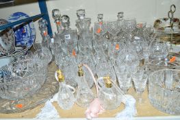 A GROUP OF CUT GLASSWARES, etc, to include decanters, scent bottles, candlesticks, glasses, etc