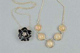 TWO PENDANT NECKLACES, the first designed as a black enamel flower with paste centre to the