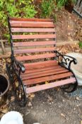 A CAST IRON GARDEN ROCKING CHAIR, with wooden slatted seats