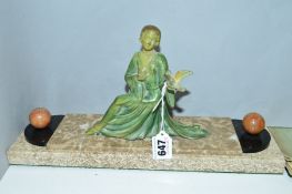 AN ART DECO PAINTED METAL FIGURE OF A LADY, with a dove on her hand, on a marble and slate base,