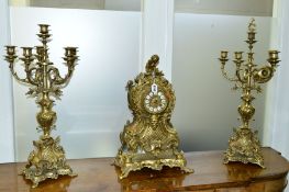 A 20TH CENTURY NEO-ROCCOCO STYLE GILT METAL CLOCK GARNITURE, the clock with enamel dial and Roman