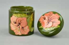 A MOORCROFT POTTERY COVERED POT, 'Hibiscus' pattern on green ground, impressed marks to base,