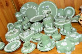 A COLLECTION OF WEDGWOOD GREEN JASPERWARE, including candlesticks, trinket boxes, plates, vases,