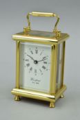 A MODERN BRASS CARRIAGE CLOCK, dial named 'Woodford Est 1860', height to top of handle 15cm