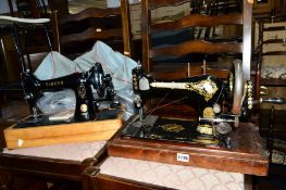 A DISTRESSED OAK CASED SINGER SEWING MACHINE, and another sewing machine (2)
