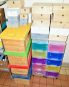 FOUR WOODEN STORAGE BOXES WITH COLOURED LIDS, (toy boxes?) and a quantity of smaller plastic boxes