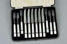 A CASED SET OF MOTHER OF PEARL HANDLED DESSERT KNIVES AND FORKS, black line detail, stainless