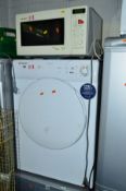 A CANDY 8KG VENTED TUMBLE DRYER, and a Sharp microwave (2)