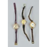 THREE EARLY 20TH CENTURY WATCHES, with 9ct gold heads and leather straps, head diameters 21mm to