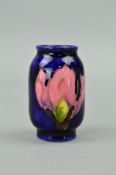 A MINIATURE MOORCROFT POTTERY VASE, magnolia pattern on blue ground, green backstamp, approximate