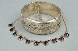 A GARNET NECKLACE AND A SILVER BANGLE, the necklace designed as square garnet cabochons within