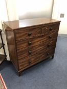 A GEORGIAN MAHOGANY CHEST, of two short and three long graduated drawers with turned handles, on