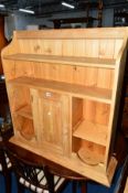 A PINE WALL HANGING CABINET, with a single door