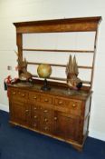 AN EARLY 19TH CENTURY OAK DRESSER, the upper section with a painted back board, three shelf