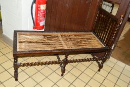 AN EARLY 20TH CENTURY CARVED OAK BARLEY TWIST CHILD'S DAY BED, with a single raised end and rattan