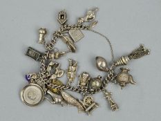 A CHARM BRACELET, the curb link bracelet suspending twenty three charms, to include an enamel town