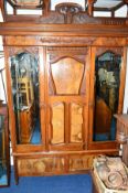 AN EDWARDIAN WALNUT TWO PIECE BEDROOM SUITE, comprising of a mirrored two door wardrobe with central