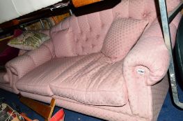 A PINK UPHOLSTERED BUTTONED TWO PIECE SUITE comprising of two x two seater sofas