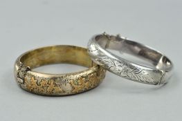 TWO HINGED SILVER BANGLES, the first with applied leaf and bird decoration to the half bangle,