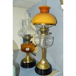 TWO BRASS BASED OIL LAMPS, both with glass reservoirs and shades, height of tallest approximately
