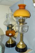 TWO BRASS BASED OIL LAMPS, both with glass reservoirs and shades, height of tallest approximately