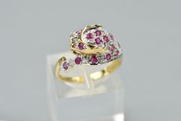 A 9CT GOLD RUBY LEOPARD HEAD RING, designed as a leopards head pave set with circular rubies and a