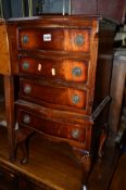 A REPRODUCTION MAHOGANY CHEST, of four various drawers on cabriole legs