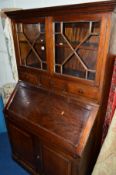 AN EDWARDIAN BUREAU/BOOKCASE, with double glazed doors above three drawers, fall front section