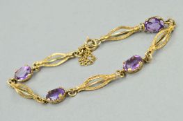 AN AMETHYST BRACELET, designed as four oval amethysts interspaced by openwork, billow shaped,
