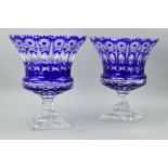 A PAIR OF FLASH CUT BLUE TO CLEAR URN SHAPED VASES, having separated rims above wheel cut stars with