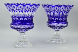 A PAIR OF FLASH CUT BLUE TO CLEAR URN SHAPED VASES, having separated rims above wheel cut stars with