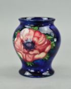 A SMALL MOORCROFT POTTERY POT, 'Anemone' pattern on blue ground, impressed marks to base,