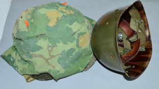 A BELGIUM MILITARY HELMET, possibly post WWII, all complete with plastic liner and camouflage cover,