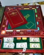 A FRANKLIN MINT COLLECTORS EDITION OF MONOPOLY, in a mahogany finish table top board fitted with a