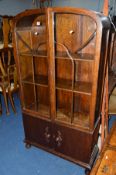 AN ART DECO STYLE OAK ASTRAGAL GLAZED TWO DOOR BOOKCASE, above double cupboard doors, approximate