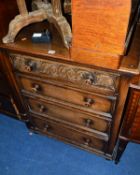 A CARVED OAK CHEST OF FOUR LONG GRADUATED DRAWERS, approximate size width 77cm x depth 47cm x height