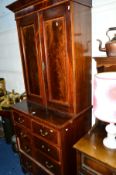 AN EDWARDIAN MAHOGANY, INLAID AND SATINWOOD BANDED TWO DOOR BOOKCASE, above two short and three long