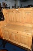 A PINE PANELLED HALL SETTLE, with a hinged lid, approximate size width 90cm