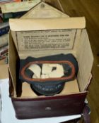 A WWII ERA BRITISH GAS MASK, this example being contained in the usual card box, but then inside a