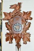 A REPRODUCTION CUCKOO CLOCK, with pendulum