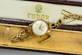 A 9CT GOLD TUDOR WRISTWATCH, the circular dial with baqton hour markers to the open link strap,