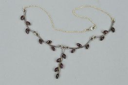 A GARNET NECKLACE, the four curved branch and leaf designed links set with leaf shaped garnet