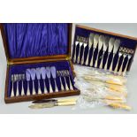 AN OAK CASED SET OF TWELVE SILVER PLATED FISH EATERS, together with other fish eaters loose (2)