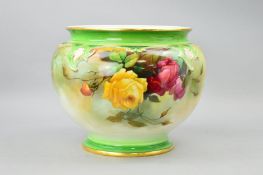 A ROYAL WORCESTER FOOTED JARDINIERE, decorated in the Hadley Roses, signed by J.W.Sedgley, green