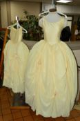 TWO BRIDESMAID DRESSES, for adult and child, buttermilk/golden in colour, fitted bodice with full